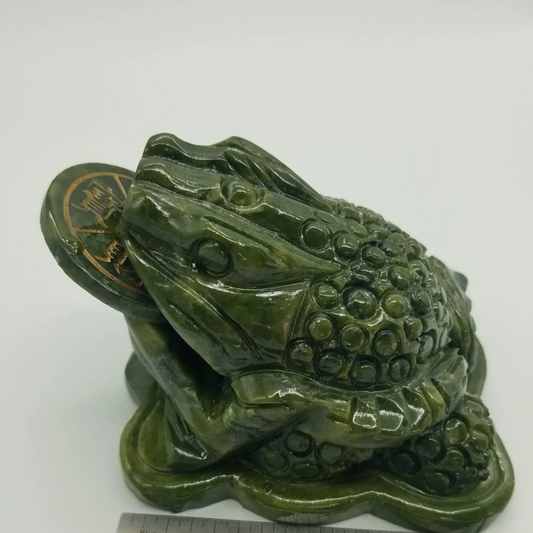 Hand-carved jade money frog with a rotating coin in its mouth, detailed and polished, displayed on a white background. Perfect for attracting prosperity, good fortune, and Feng Shui blessings.