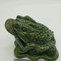 Hand-carved jade money frog with a rotating coin in its mouth, detailed and polished, displayed on a white background. Perfect for attracting prosperity, good fortune, and Feng Shui blessings.