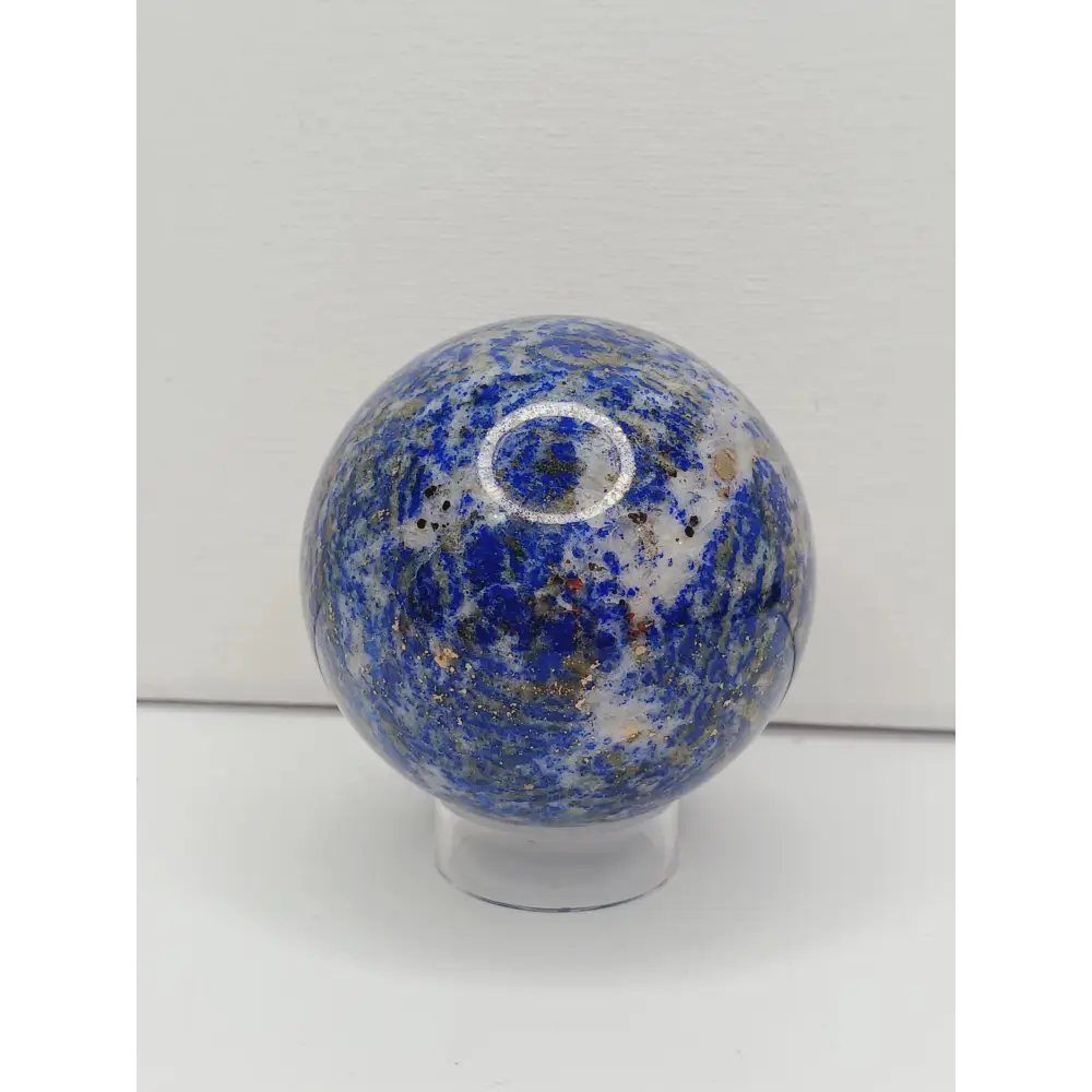 Decorative knob with blue and gold speckled pattern on a white background