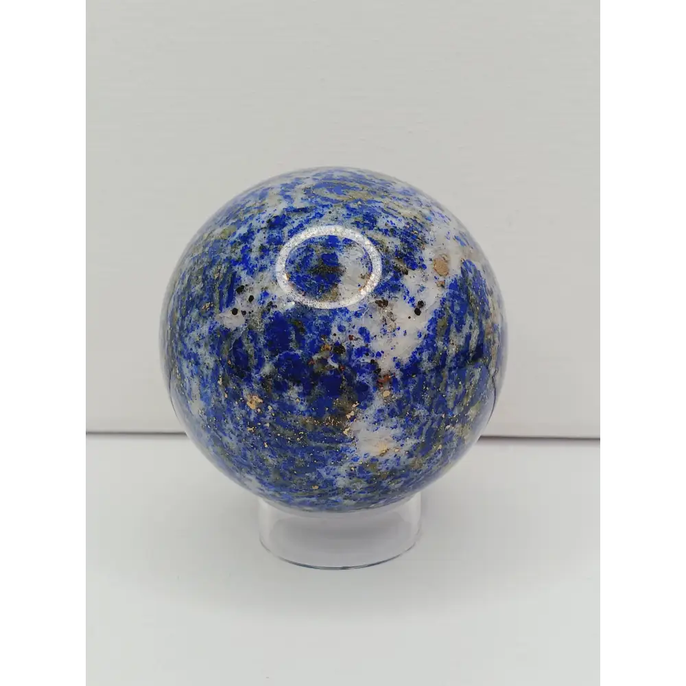 Decorative knob with blue and white speckled pattern on a white background