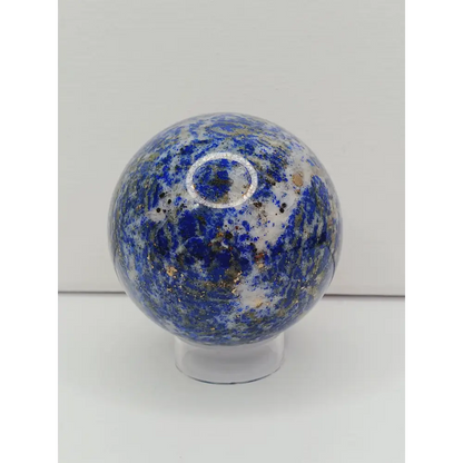 Decorative knob with blue and white speckled pattern on a white background