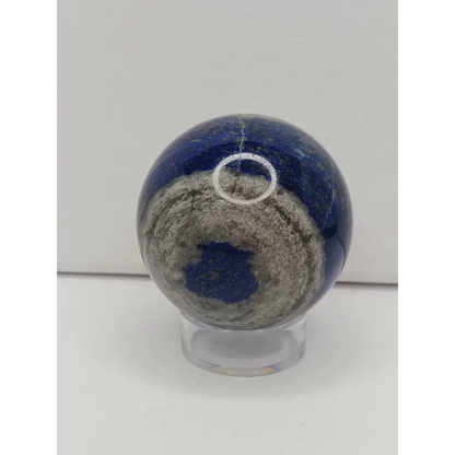 Close-up of a blue and gray stone with a white circle on a light gray background