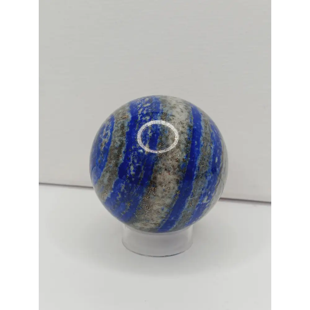 Decorative knob with blue and gray striped pattern on a white background