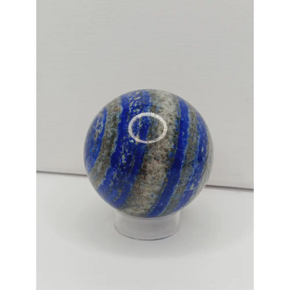 Decorative knob with blue and gray striped pattern on a white background