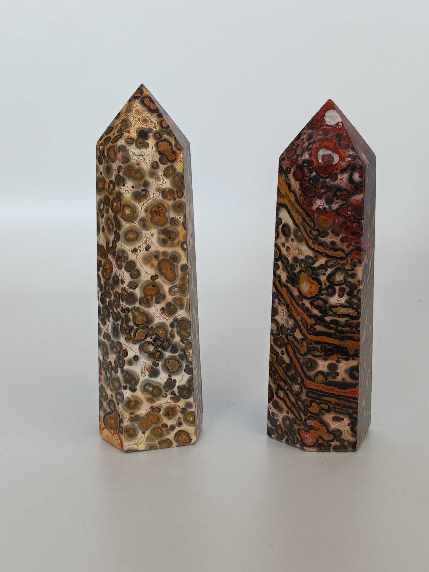 Hand-carved Leopard Jasper point featuring bold, earthy spotted patterns and a polished finish, displayed on a white background.