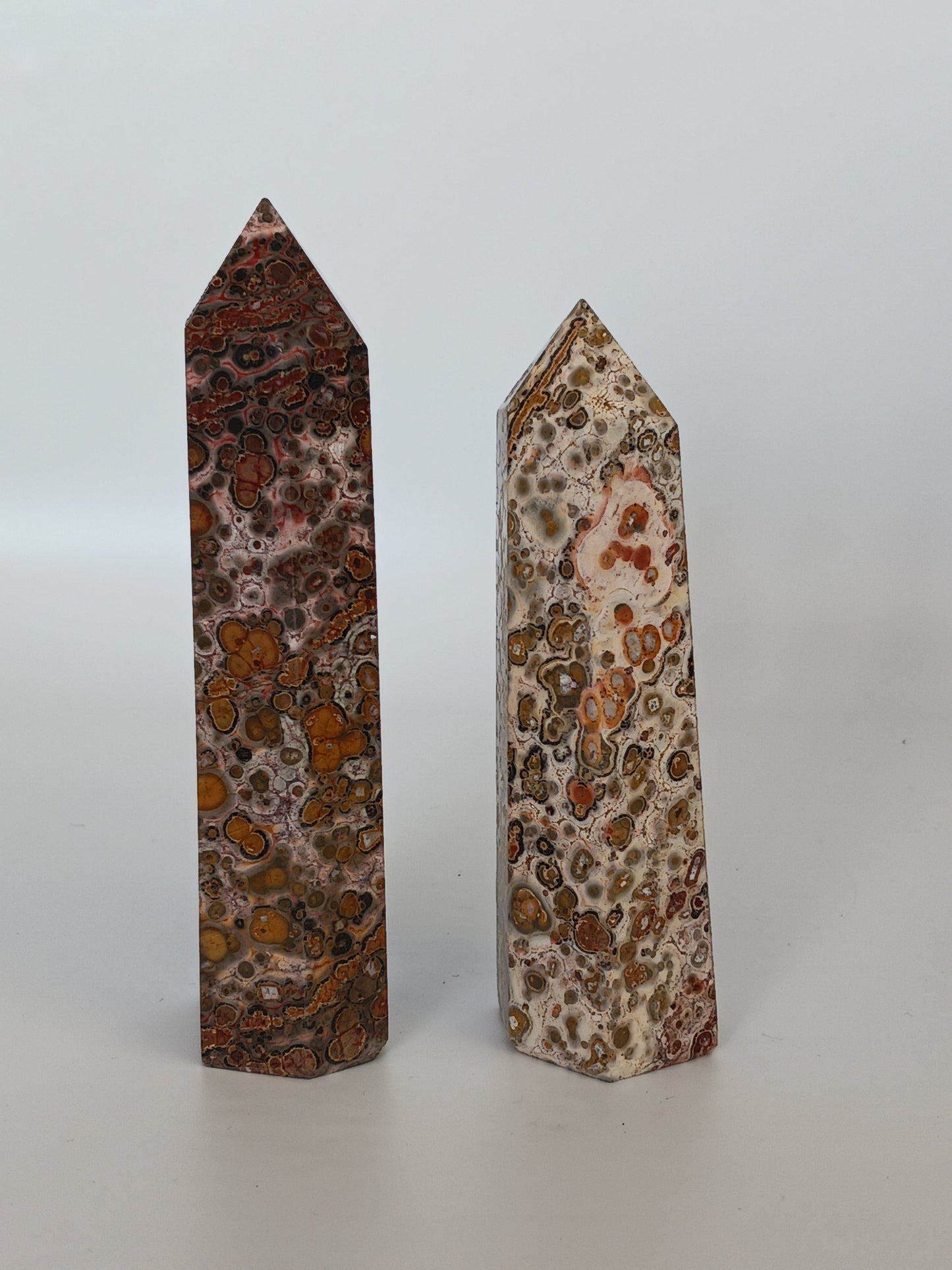 Hand-carved Leopard Jasper point featuring bold, earthy spotted patterns and a polished finish, displayed on a white background.