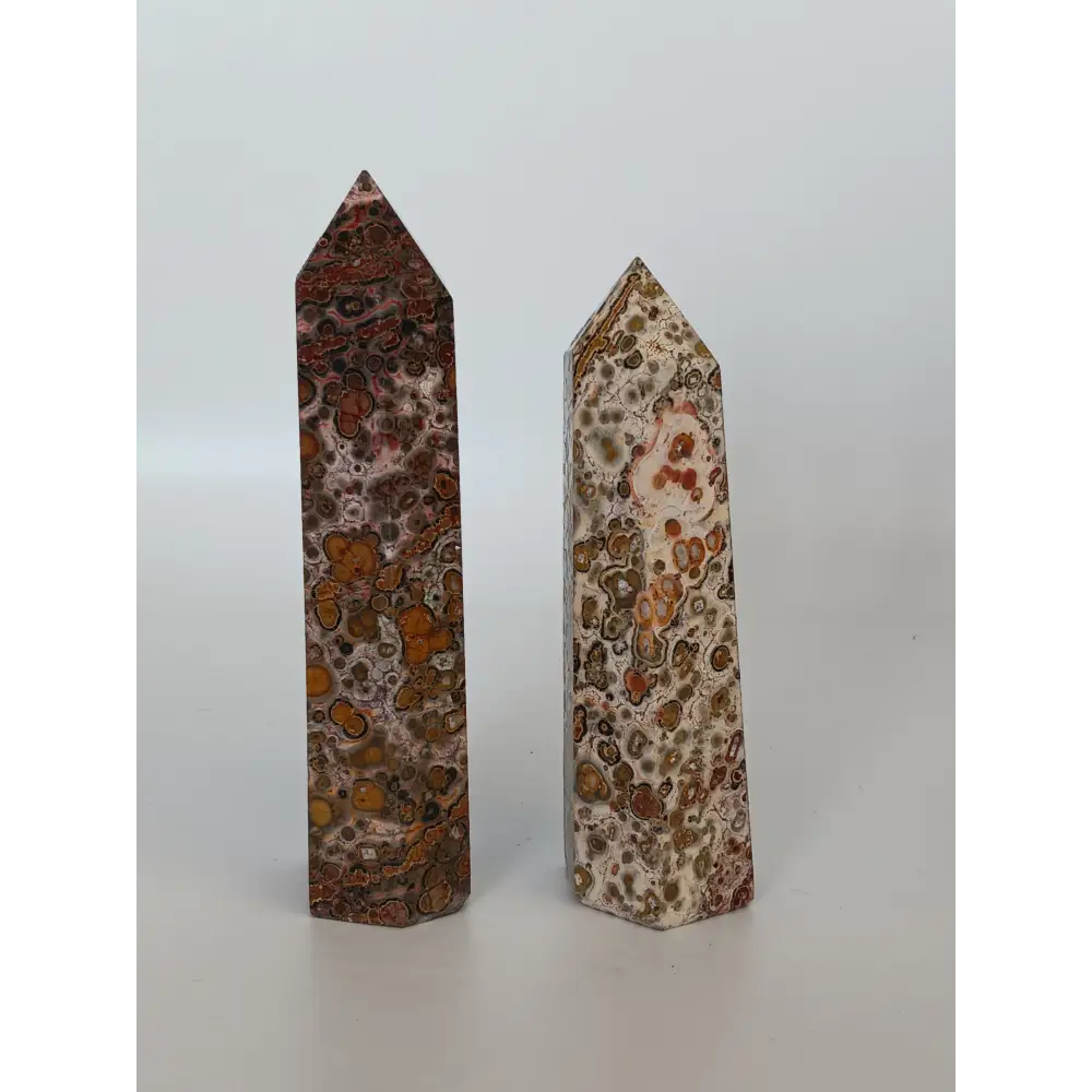 Hand-carved Leopard Jasper point featuring bold, earthy spotted patterns and a polished finish, displayed on a white background.