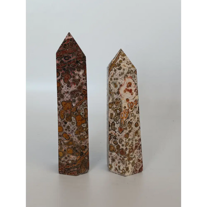 Hand-carved Leopard Jasper point featuring bold, earthy spotted patterns and a polished finish, displayed on a white background.