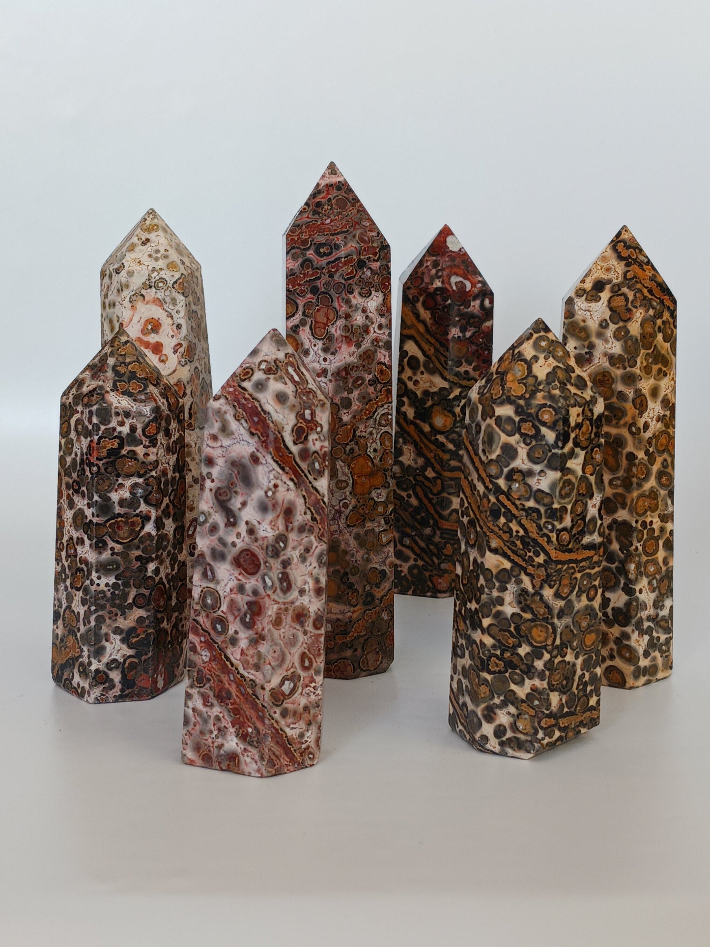 Hand-carved Leopard Jasper point featuring bold, earthy spotted patterns and a polished finish, displayed on a white background.