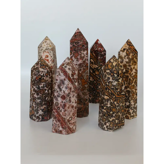 Hand-carved Leopard Jasper point featuring bold, earthy spotted patterns and a polished finish, displayed on a white background.