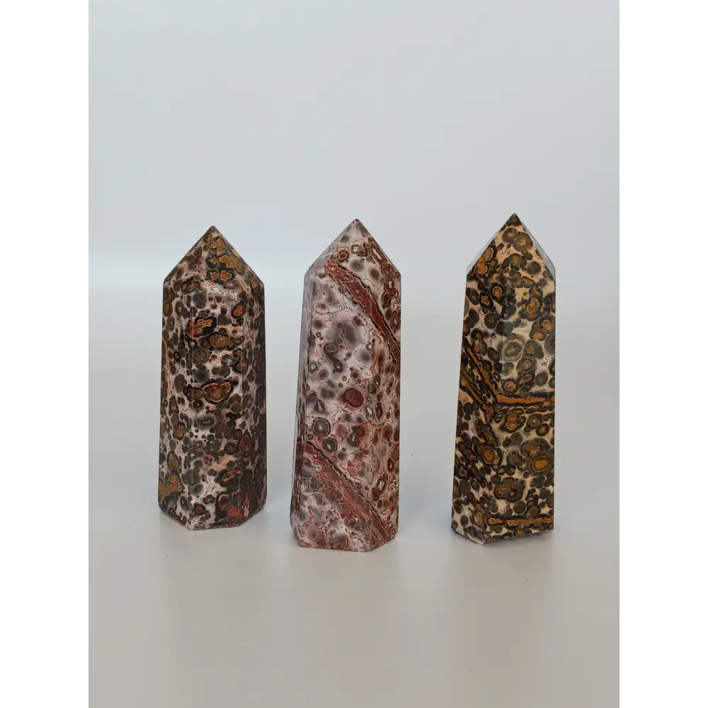 Hand-carved Leopard Jasper point featuring bold, earthy spotted patterns and a polished finish, displayed on a white background.