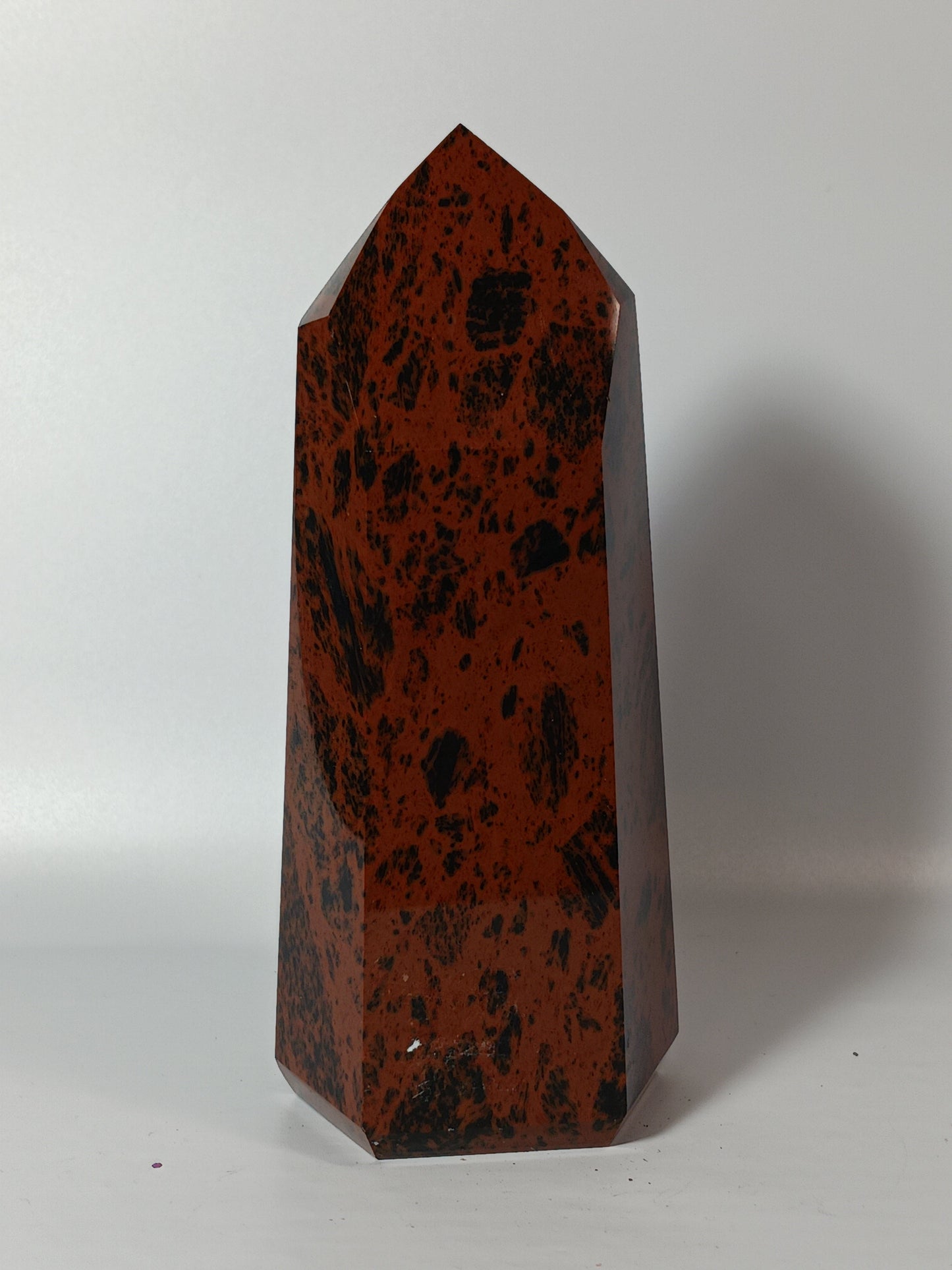 Hand-carved Mahogany Obsidian tower with rich brown and black swirls, displayed on a white background.