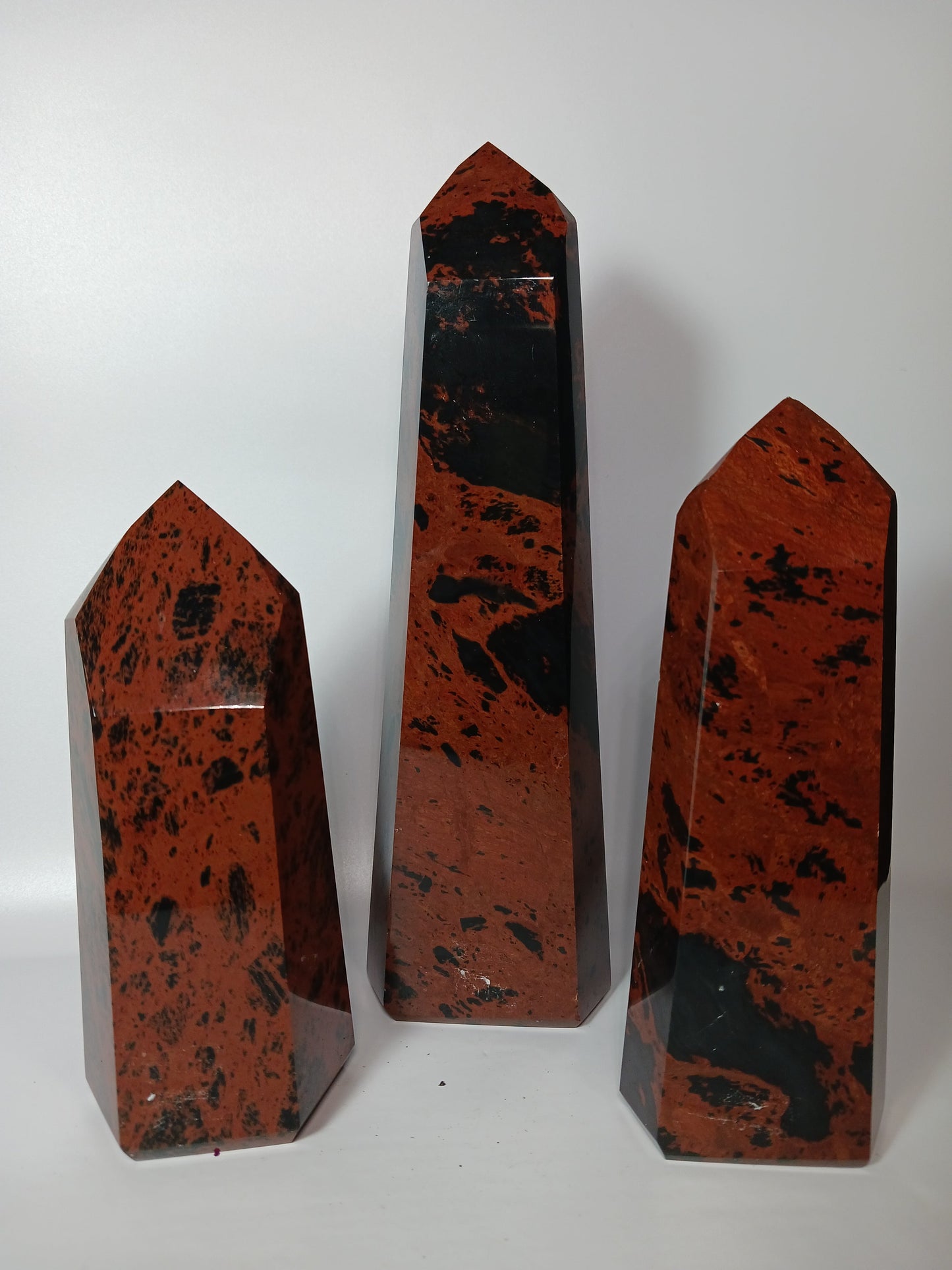 Hand-carved Mahogany Obsidian tower with rich brown and black swirls, displayed on a white background.