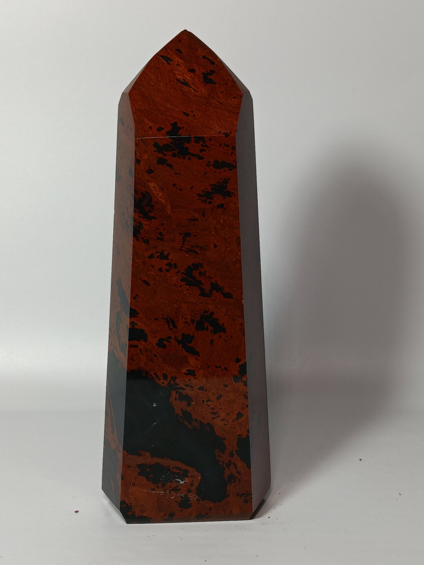 Hand-carved Mahogany Obsidian tower with rich brown and black swirls, displayed on a white background.