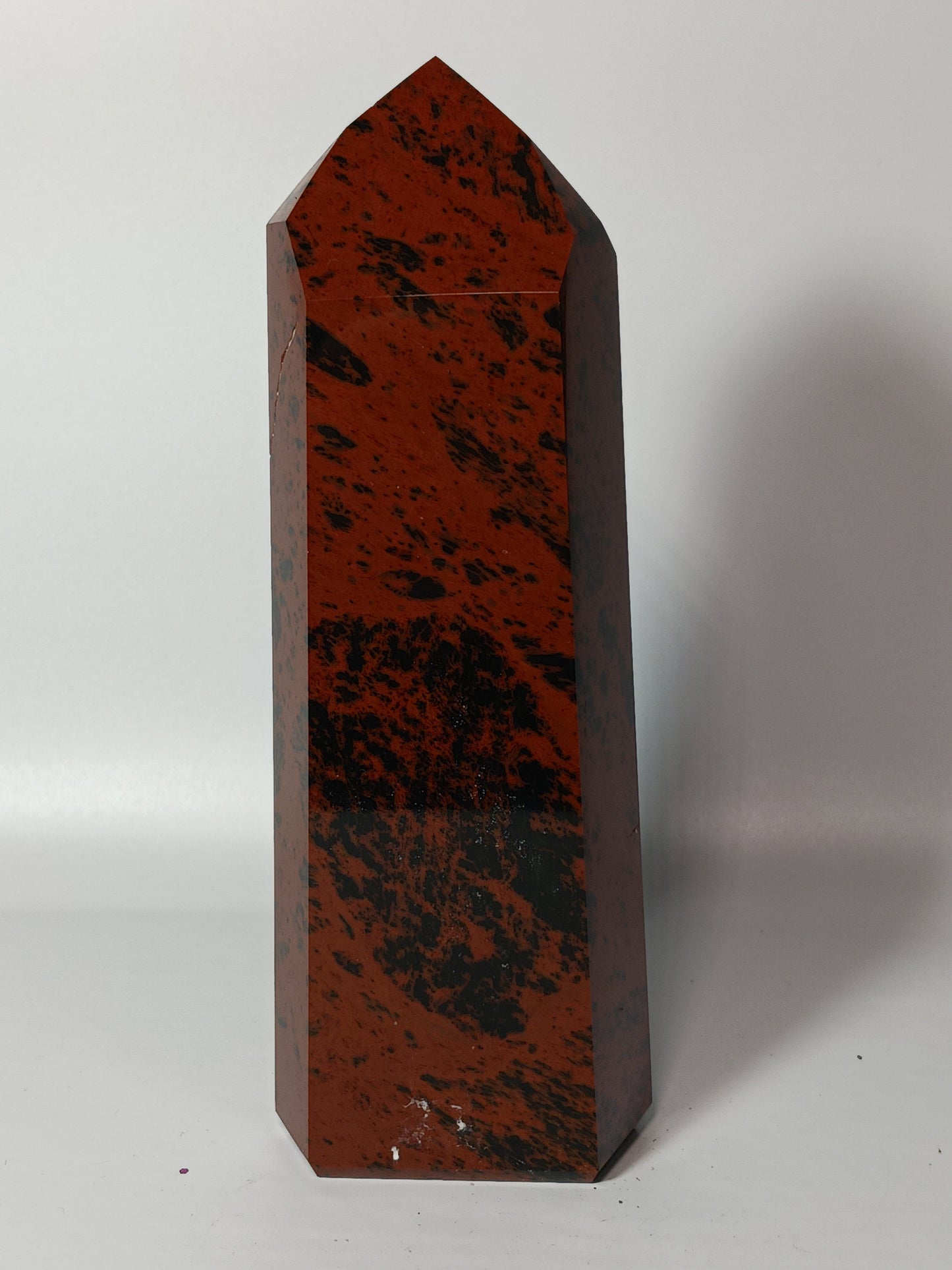 Hand-carved Mahogany Obsidian tower with rich brown and black swirls, displayed on a white background.