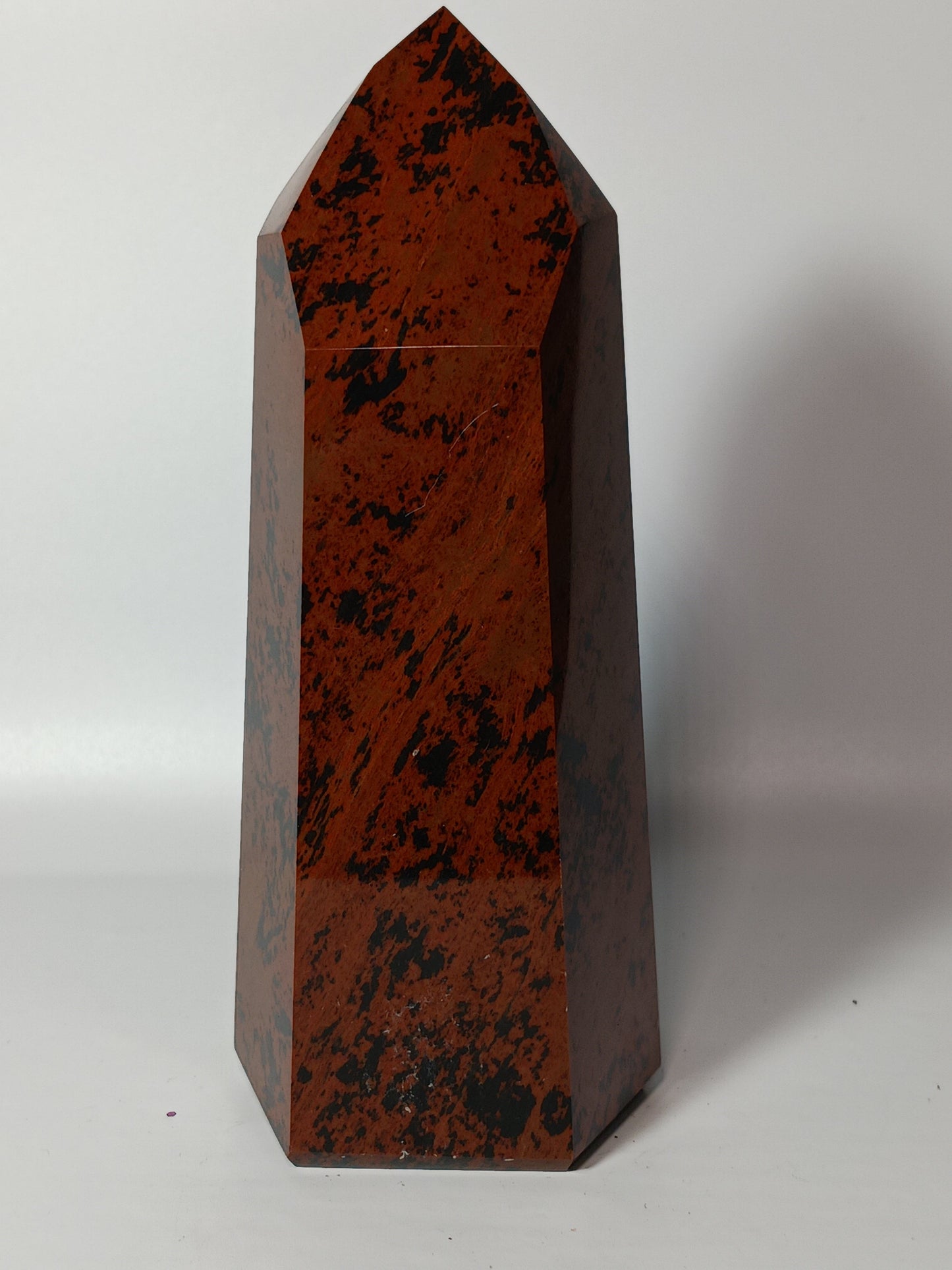 Hand-carved Mahogany Obsidian tower with rich brown and black swirls, displayed on a white background.