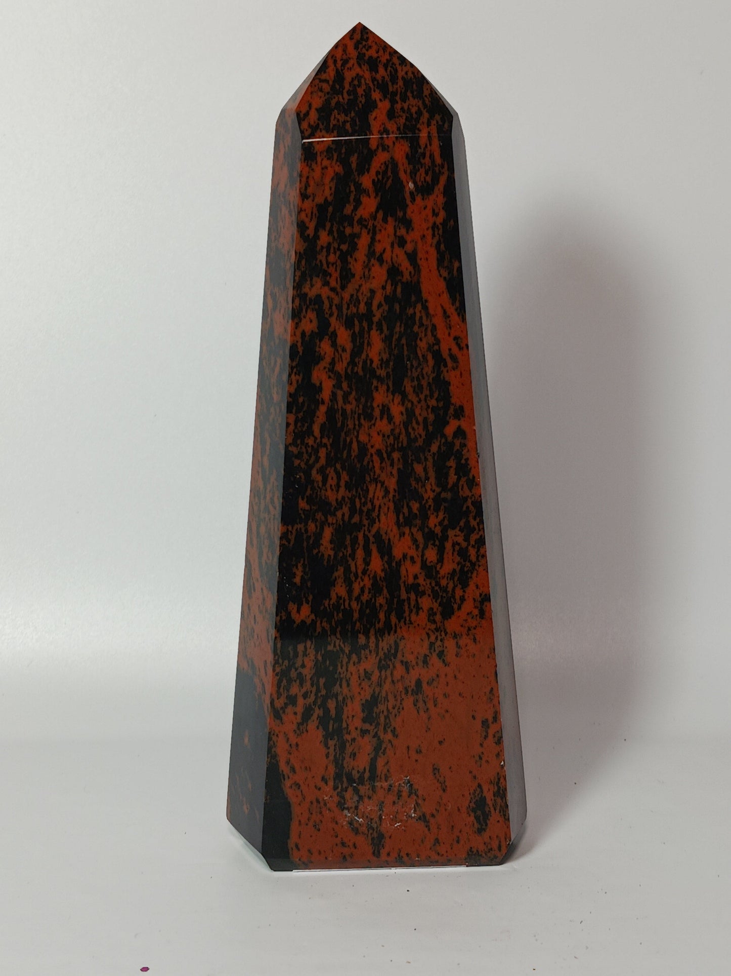 Hand-carved Mahogany Obsidian tower with rich brown and black swirls, displayed on a white background.