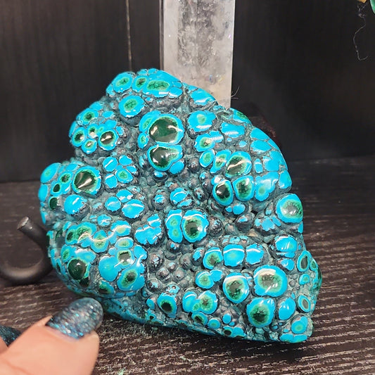 Malachite and chrysocolla specimen with vibrant green bands and blue-teal hues, displayed on a white background. Perfect for transformation, heart healing, and inner wisdom.