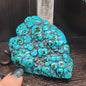 Malachite and chrysocolla specimen with vibrant green bands and blue-teal hues, displayed on a white background. Perfect for transformation, heart healing, and inner wisdom.