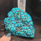 Malachite and chrysocolla specimen with vibrant green bands and blue-teal hues, displayed on a white background. Perfect for transformation, heart healing, and inner wisdom.