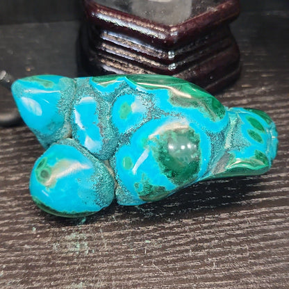Malachite and chrysocolla specimen with vibrant green bands and blue-teal hues, displayed on a white background. Perfect for transformation, heart healing, and inner wisdom.