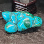 Malachite and chrysocolla specimen with vibrant green bands and blue-teal hues, displayed on a white background. Perfect for transformation, heart healing, and inner wisdom.