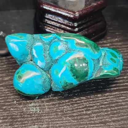 Malachite and chrysocolla specimen with vibrant green bands and blue-teal hues, displayed on a white background. Perfect for transformation, heart healing, and inner wisdom.