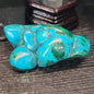 Malachite and chrysocolla specimen with vibrant green bands and blue-teal hues, displayed on a white background. Perfect for transformation, heart healing, and inner wisdom.
