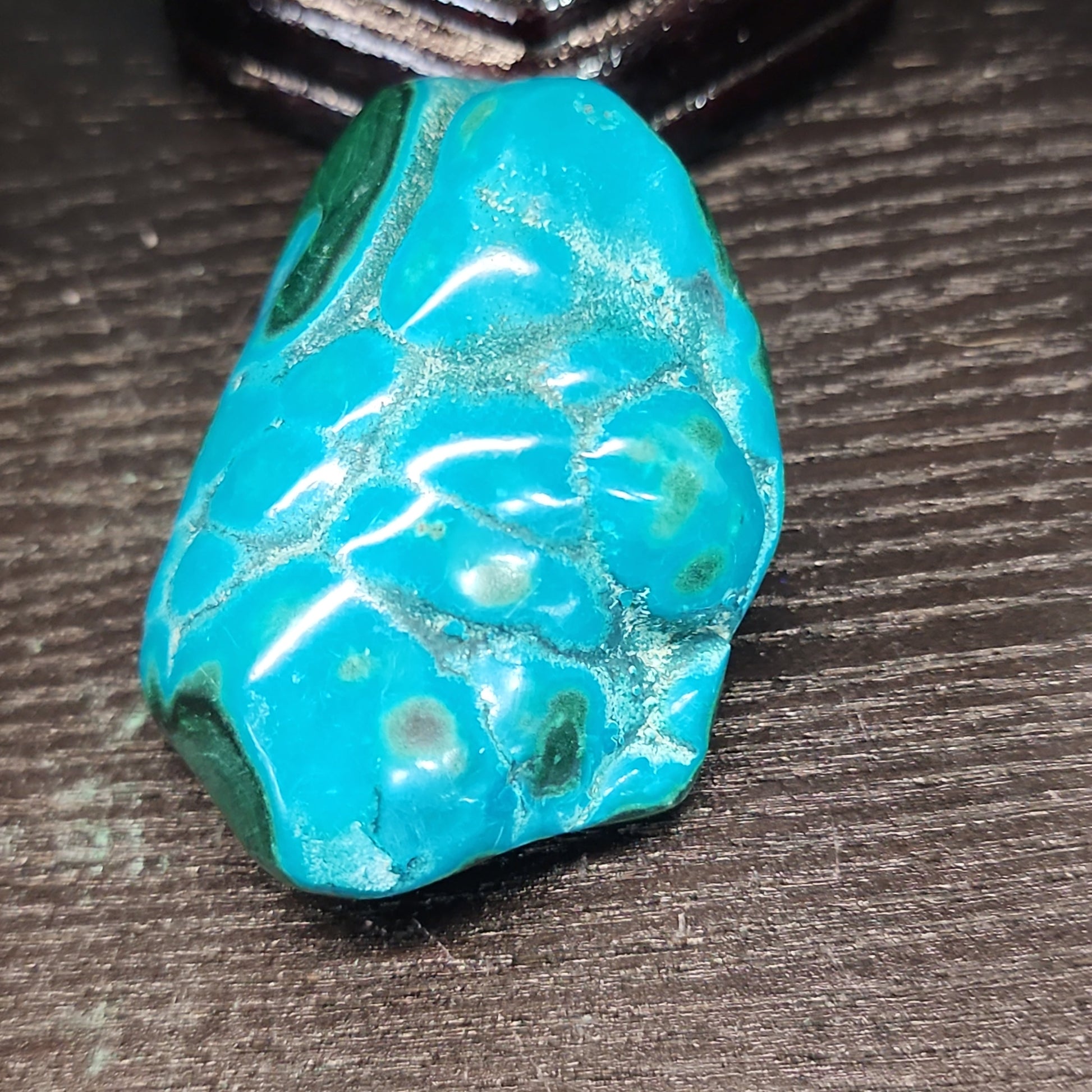 Malachite and chrysocolla specimen with vibrant green bands and blue-teal hues, displayed on a white background. Perfect for transformation, heart healing, and inner wisdom.