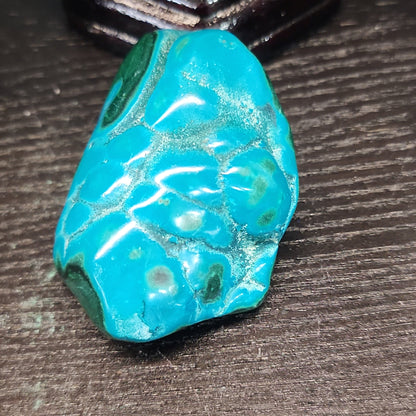 Malachite and chrysocolla specimen with vibrant green bands and blue-teal hues, displayed on a white background. Perfect for transformation, heart healing, and inner wisdom.