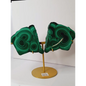 Pair of polished malachite slabs with vibrant green banding, displayed upright on a metal stand against a white background.