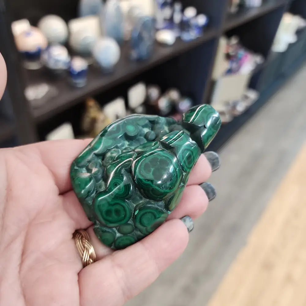 Hand-selected malachite specimen with vibrant green bands and natural patterns, displayed on a white background. Perfect for transformation, protection, and heart chakra healing.
