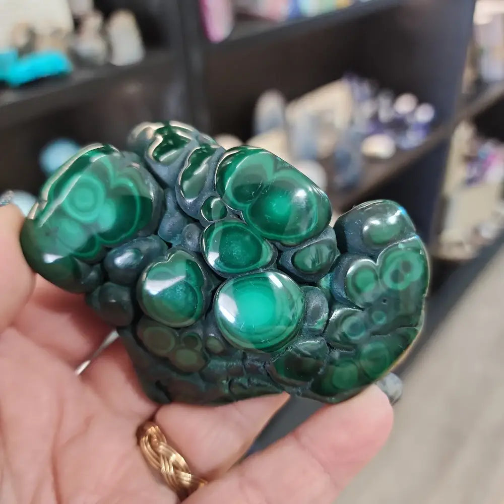 Hand-selected malachite specimen with vibrant green bands and natural patterns, displayed on a white background. Perfect for transformation, protection, and heart chakra healing.
