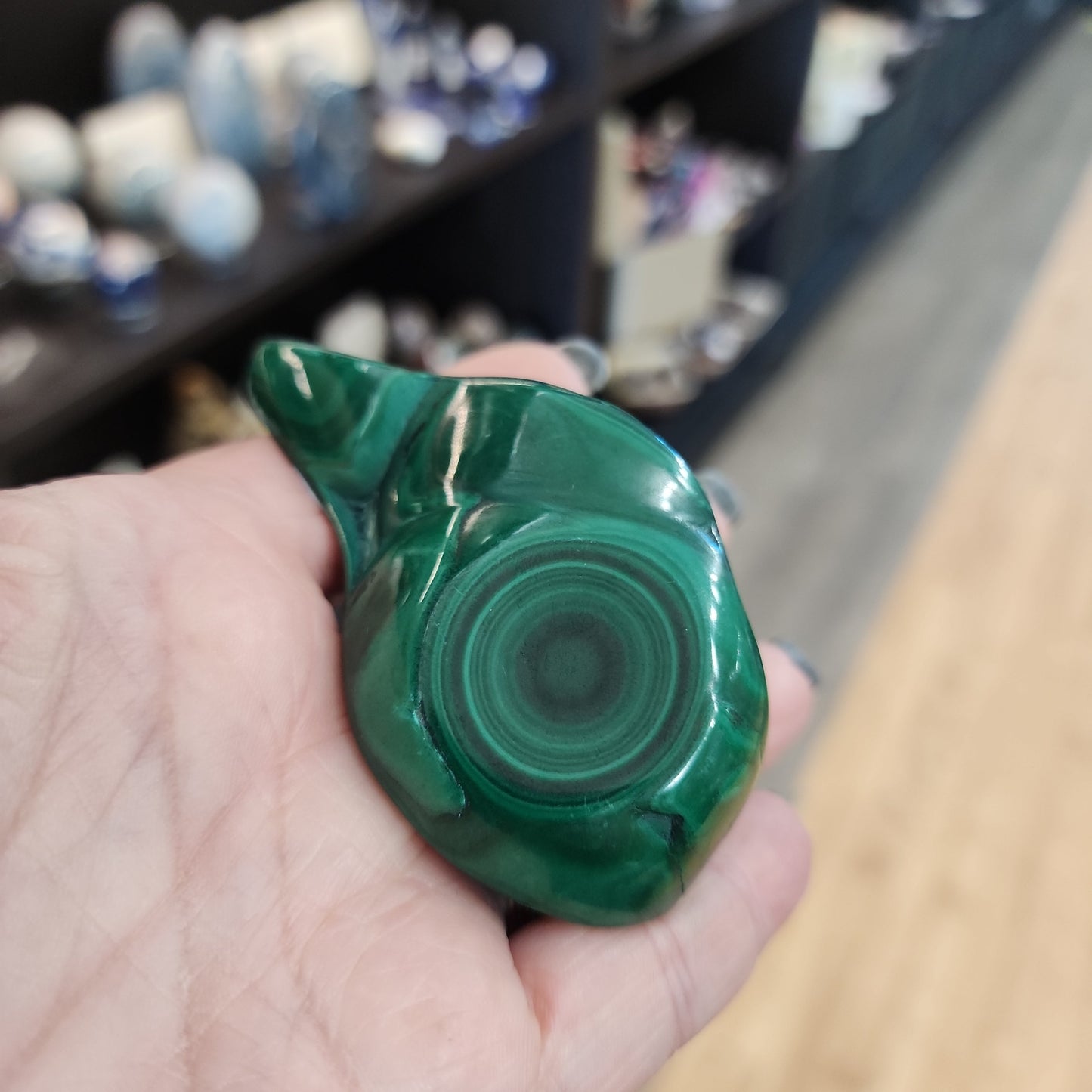 Hand-selected malachite specimen with vibrant green bands and natural patterns, displayed on a white background. Perfect for transformation, protection, and heart chakra healing.
