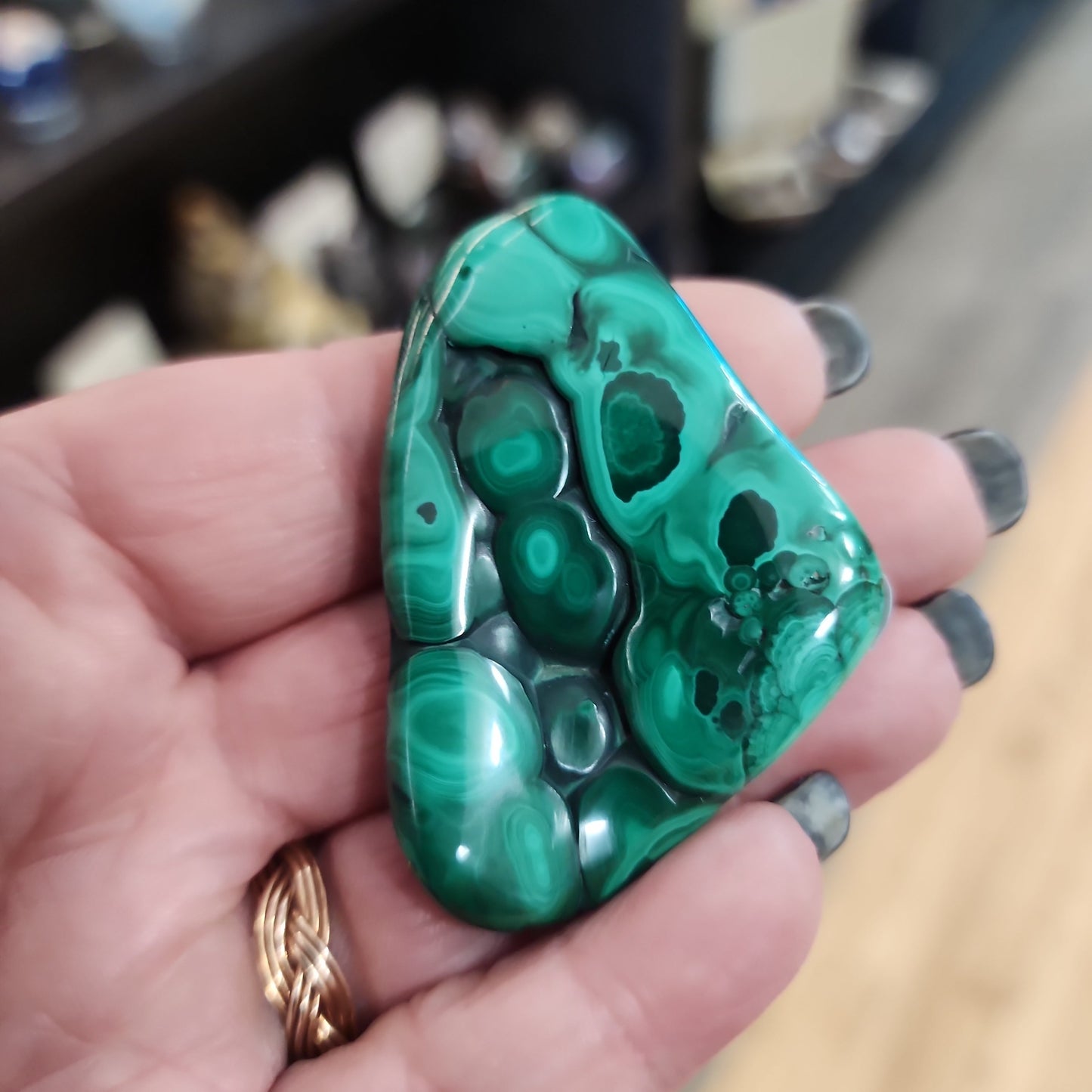 Hand-selected malachite specimen with vibrant green bands and natural patterns, displayed on a white background. Perfect for transformation, protection, and heart chakra healing.