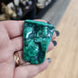 Hand-selected malachite specimen with vibrant green bands and natural patterns, displayed on a white background. Perfect for transformation, protection, and heart chakra healing.