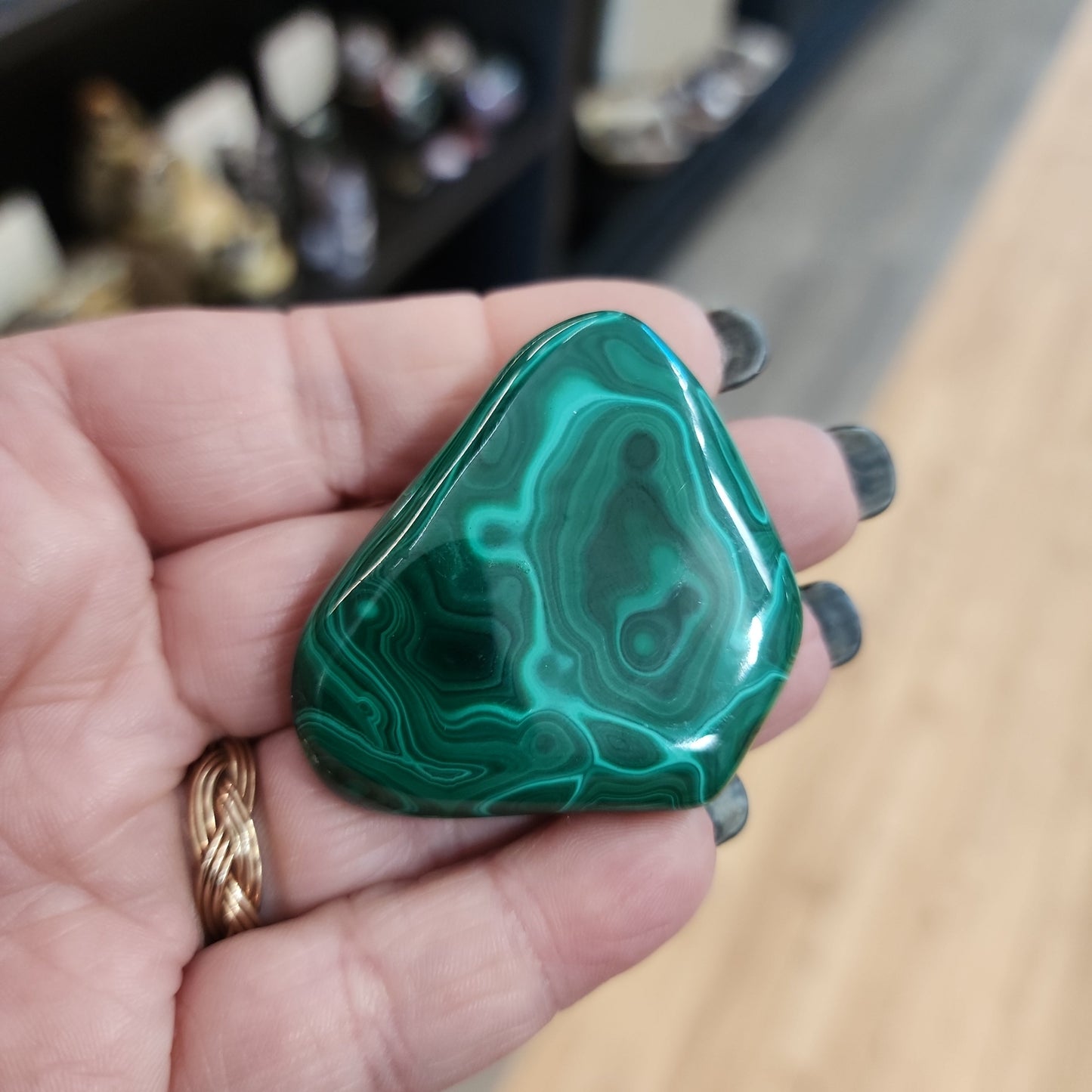 Hand-selected malachite specimen with vibrant green bands and natural patterns, displayed on a white background. Perfect for transformation, protection, and heart chakra healing.