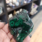 Hand-selected malachite specimen with vibrant green bands and natural patterns, displayed on a white background. Perfect for transformation, protection, and heart chakra healing.