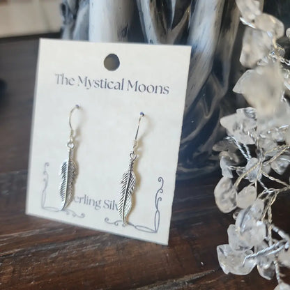 Sterling silver medium feather earrings with delicate detailing, displayed on a white background. Perfect for spiritual freedom, guidance, and everyday magic.