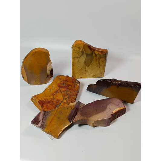 Hand-polished Mookaite slab, 2–2.5 inches, with vibrant red, yellow, and cream patterns, displayed on a white background.