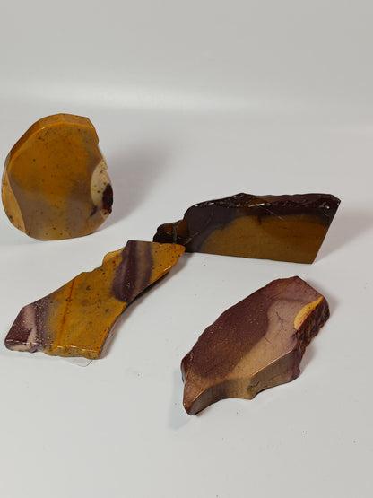 Hand-polished Mookaite slab, 2–2.5 inches, with vibrant red, yellow, and cream patterns, displayed on a white background.