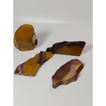 Hand-polished Mookaite slab, 2–2.5 inches, with vibrant red, yellow, and cream patterns, displayed on a white background.