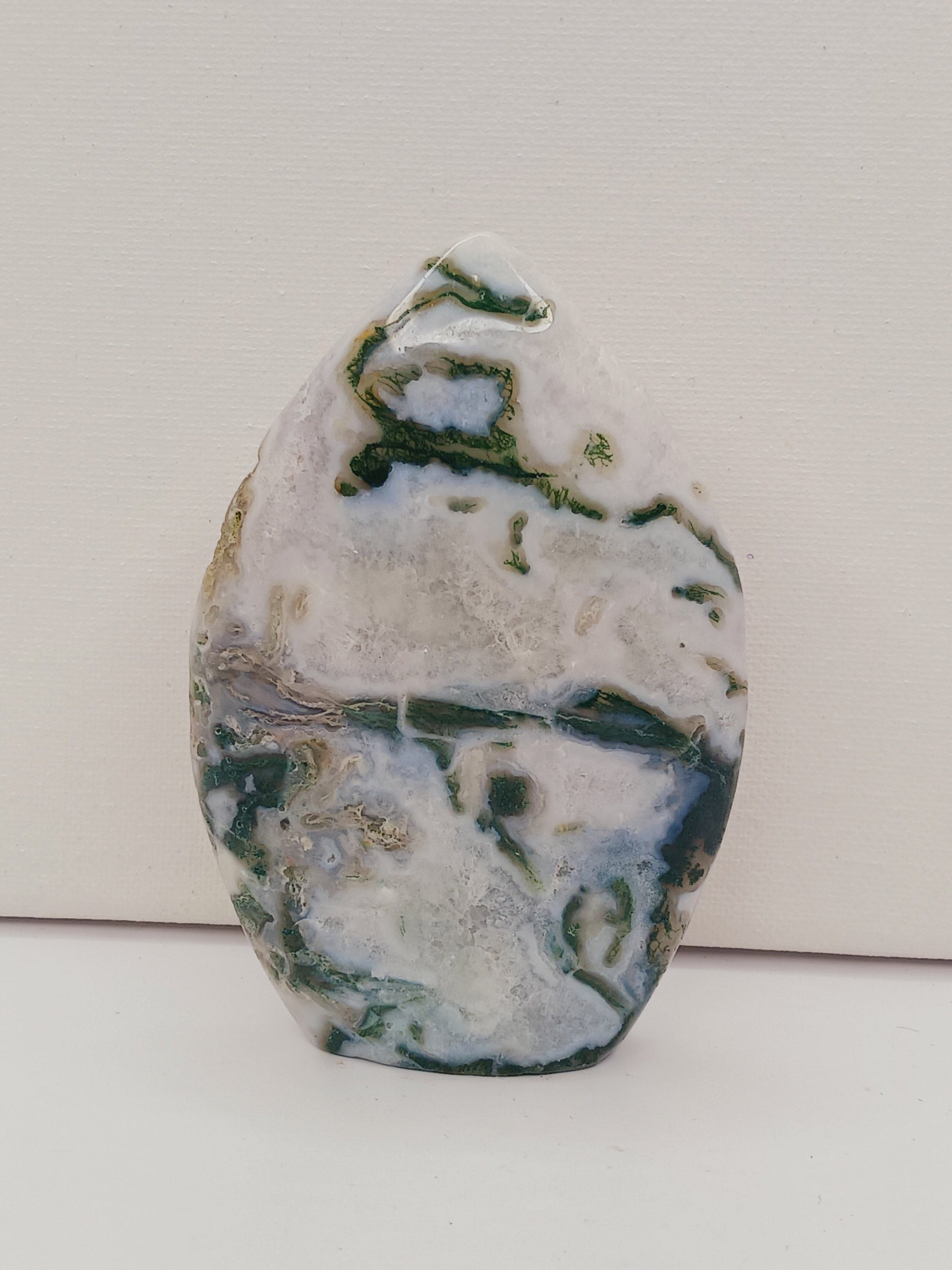 Moss Agate freeform, approx. 4 inches tall, with lush green and white patterns, displayed on a white background.