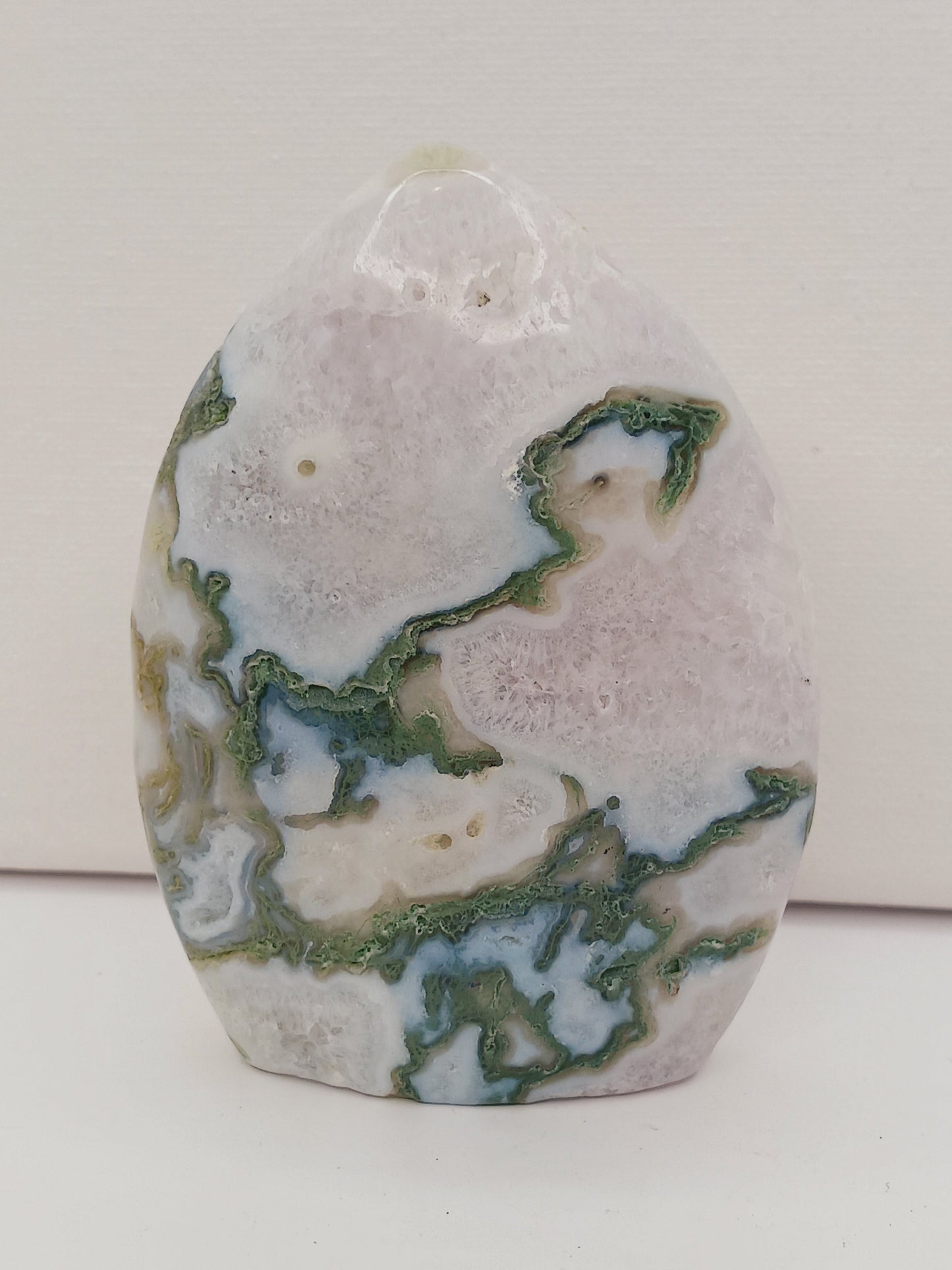 Moss Agate freeform, approx. 4 inches tall, with lush green and white patterns, displayed on a white background.