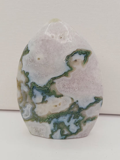 Moss Agate freeform, approx. 4 inches tall, with lush green and white patterns, displayed on a white background.