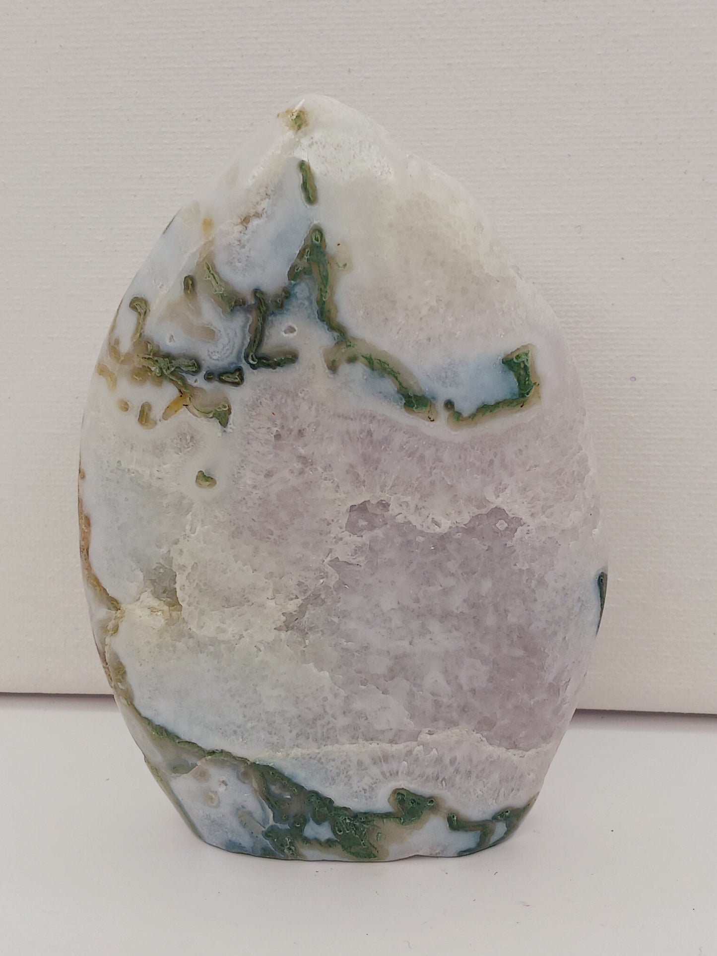 Moss Agate freeform, approx. 4 inches tall, with lush green and white patterns, displayed on a white background.