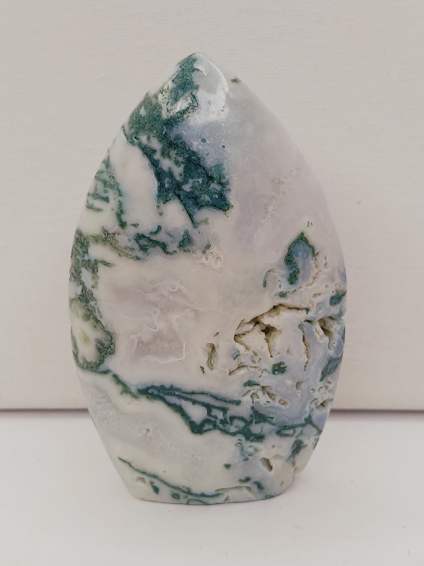 Moss Agate freeform, approx. 4 inches tall, with lush green and white patterns, displayed on a white background.