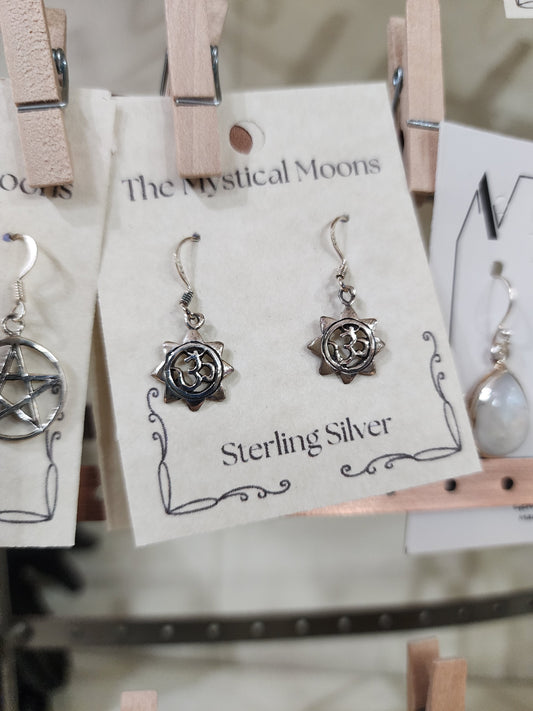 Sterling silver earrings featuring a radiant sun with the Om symbol at the center, displayed on a white background. Perfect for spiritual radiance, peace, and sacred style.