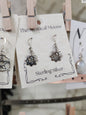 Sterling silver earrings featuring a radiant sun with the Om symbol at the center, displayed on a white background. Perfect for spiritual radiance, peace, and sacred style.