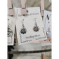 Sterling silver earrings featuring a radiant sun with the Om symbol at the center, displayed on a white background. Perfect for spiritual radiance, peace, and sacred style.